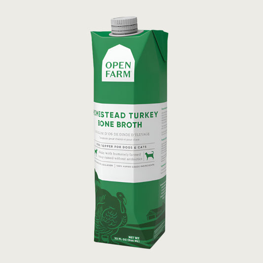 A 32 oz green & white carton with spout, of Open Farm Homestead Turkey Bone Broth Meal Topper for Dogs & Cats.
