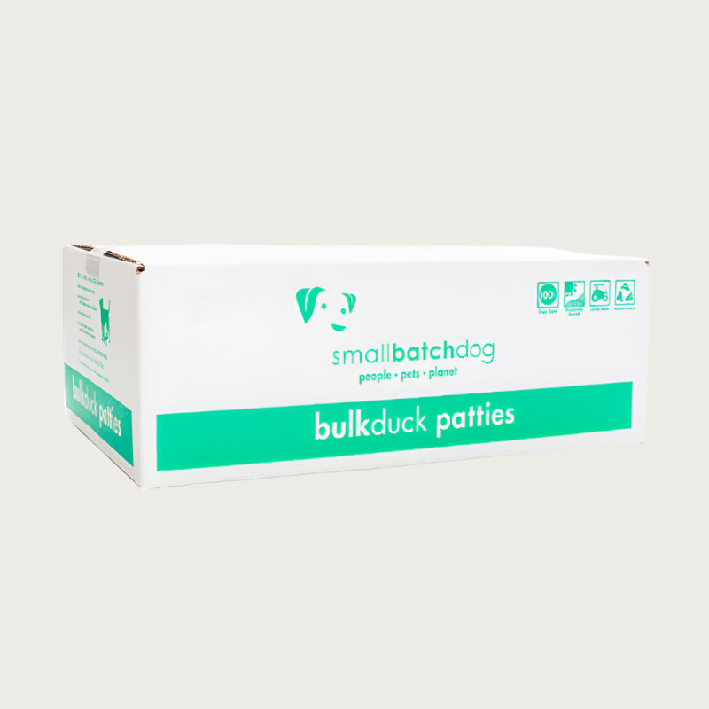 A green and white box of Smallbatch duck batch recipe, frozen raw dog food. This 18 pound bulk box contains 36 patties.
