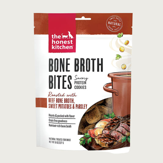 8 oz bag of Bone Broth Bites savory protein cookies from The Honest Kitchen; roasted with beef bone broth, sweet potatoes & parsley, dog treats. Small transparent window on front shows product inside: 1-2" wide brown squares.