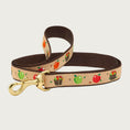 Load image into Gallery viewer, Dog leash with apple & apple bushel pattern in shades of red, green, orange and brown on a tan background. Inner webbing is brown, and the leash has a brass clip.