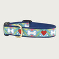 Load image into Gallery viewer, Dog collar with multicolored 60's-style pattern featuring dog bones & red hearts. Inner webbing is navy blue and the collar has a black plastic clip with brass D-ring.