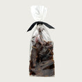 Load image into Gallery viewer, 7 oz clear cellophane bag of Wet Nose exclusive Buffalo Jerky dog treats, tied with black ribbon. Product inside is brown, rectangular shaped strips.