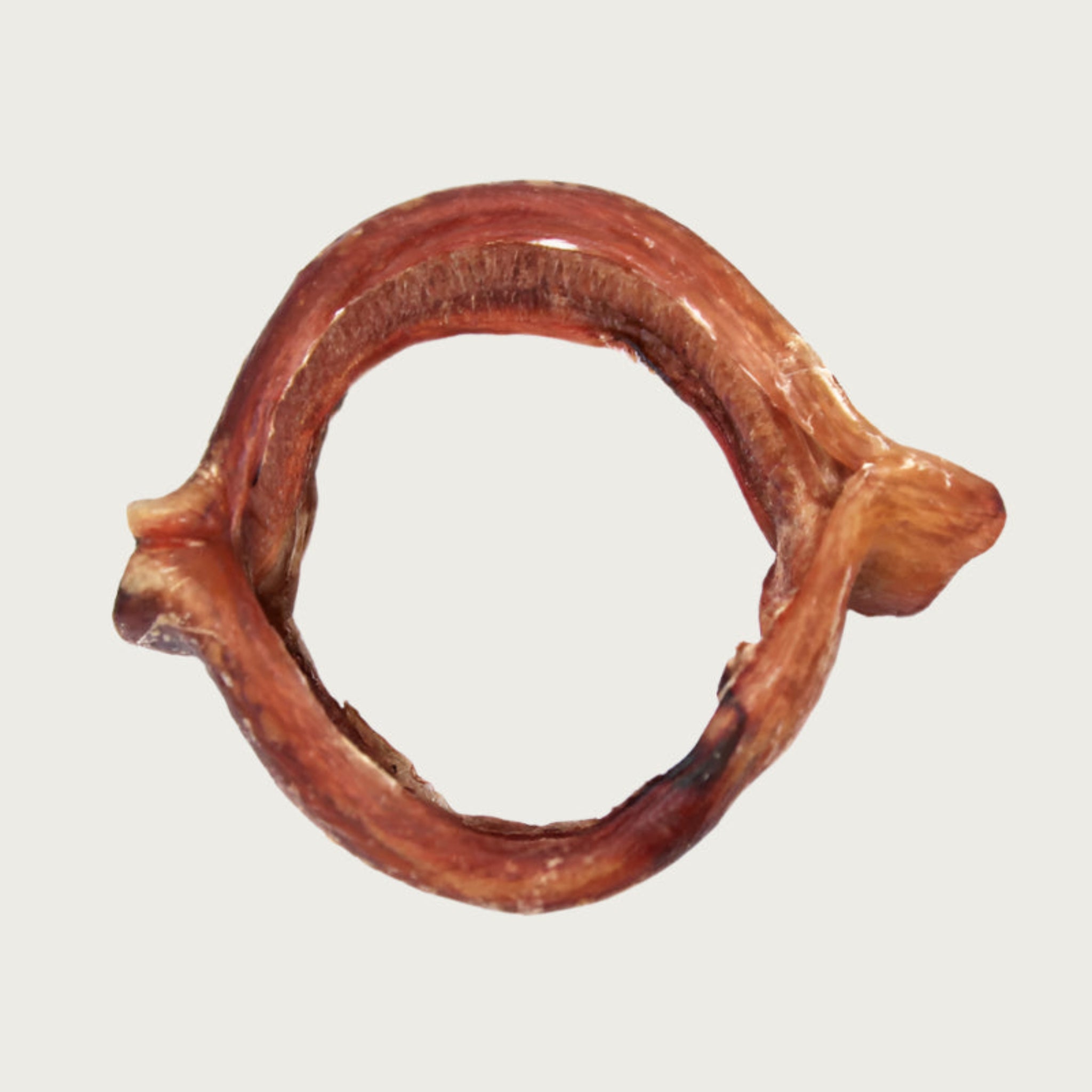 Wide, ring shaped dog chew that is reddish brown in color.