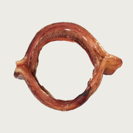 Wide, ring shaped dog chew that is reddish brown in color.