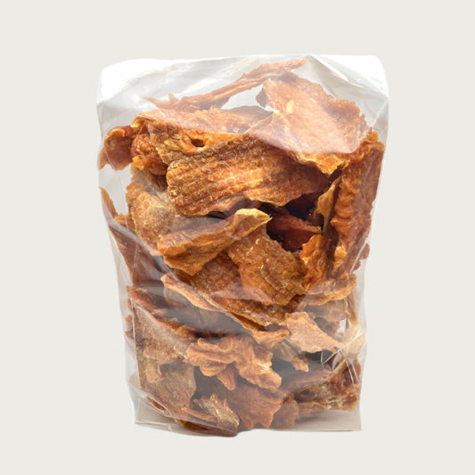 2 lb clear cellophane bag of Wet Nose exclusive Chicken Strips dog treats, tied with black ribbon. Inside are strips of chicken tenders, that are pale orangey-tan in color.