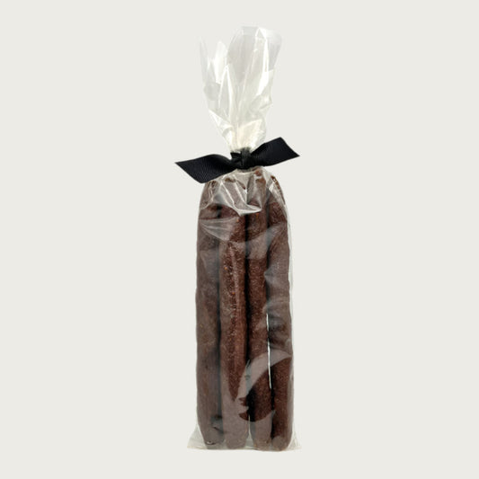 Clear cellophane bag of 5 count Wet Nose exclusive Duck Sticks dog treats, tied with black ribbon. 7"-8" sized reddish/brown sticks.