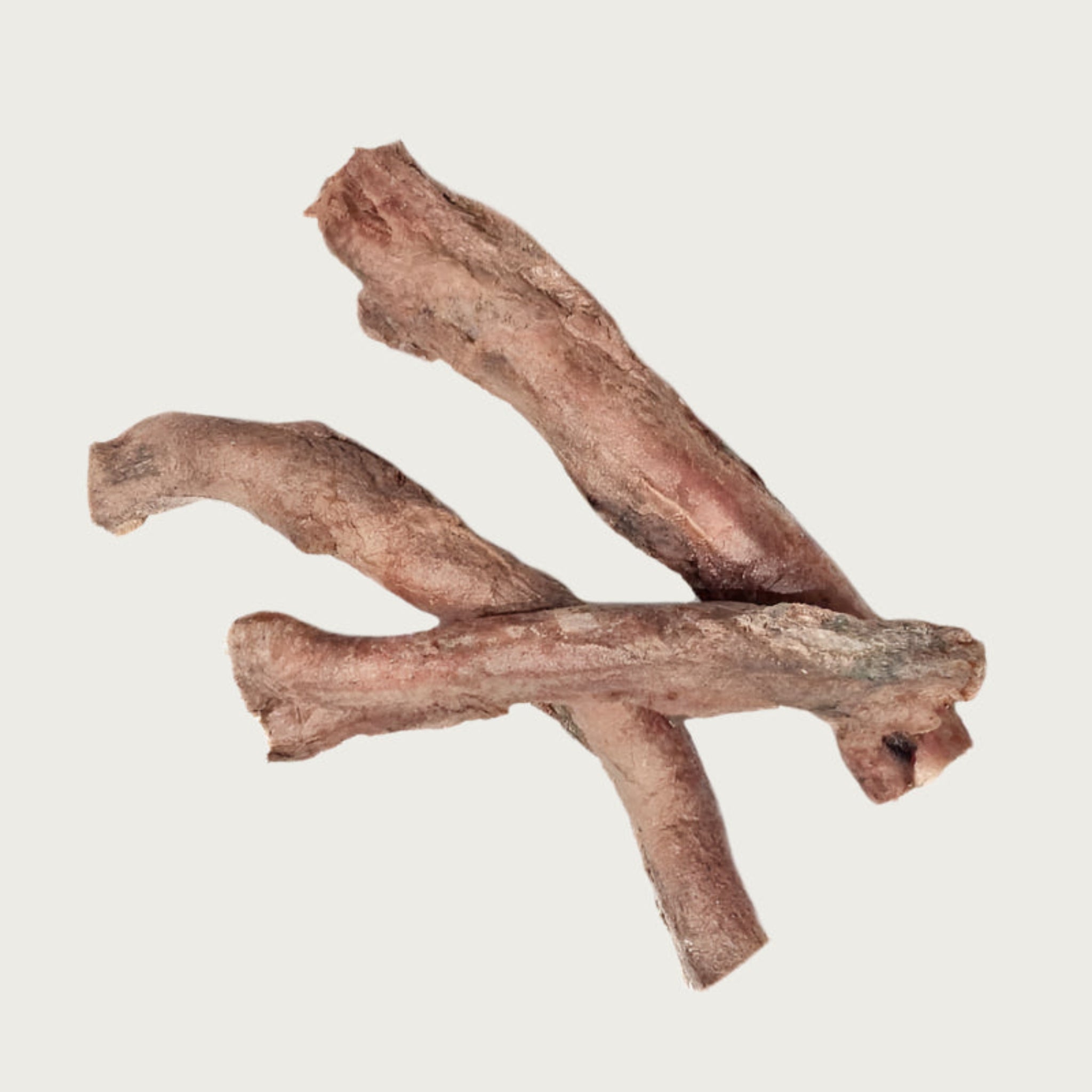 Three freeze-dried bully stick dog chews, stacked like sticks. Each has an uneven shape & width, and is light brown in color.
