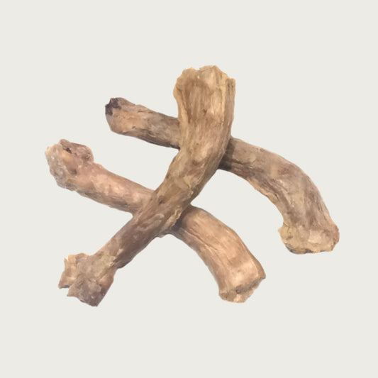 Three freeze-dried turkey necks stacked to show size & shape variation. They are light tan in color.