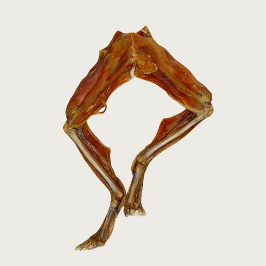 Two frog legs that are attached in the middle. They are reddish-tan in color.
