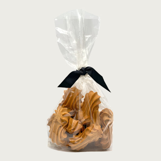 10 oz clear, cellophane bag of Wet Nose exclusive, Goobers dog treats, tied with black ribbon. Visible inside are 3" long, tan cookies with swirl texture on top.