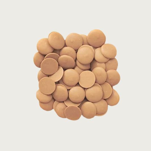 Closeup photo of a stack of Wet Nose Guilty Pleasures peanut butter treats. They are tan, disc-shaped, and measure about 1" wide.