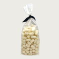 Load image into Gallery viewer, 4 oz clear cellophane bag of Wet Nose exclusive Pooch Puffs dog treats, tied with black ribbon. Treats inside are ivory colored, and look like small tater tots.