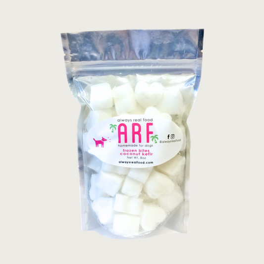 8 oz clear bag of frozen Always Real Food (ARF) Coconut Kefir Bites. Can see product inside-they are white, heart-shaped cubes.