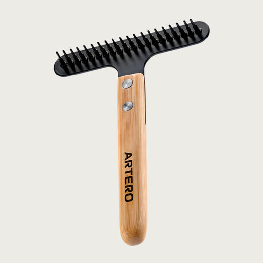 T-shaped pet grooming rake with wide-set black metal teeth and wooden handle.