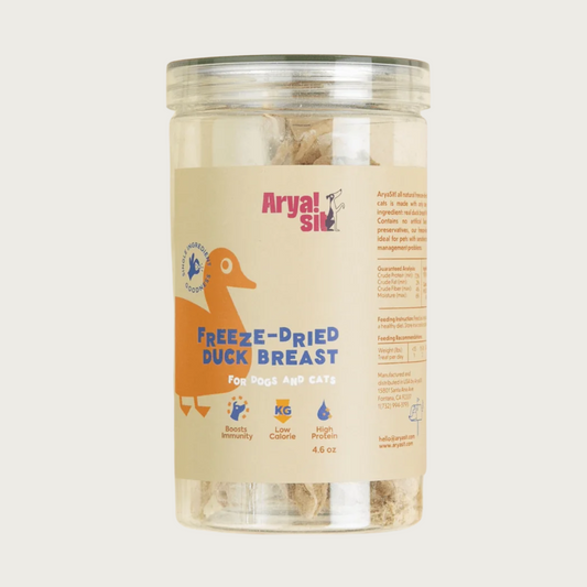Clear plastic container of Arya! Sit Freeze-Dried Duck Breast tenders for dogs & cats. Single ingredient goodness. Boosts immunity, low calorie, high protein. Product inside is visible - container is full of full-length duck breast tenders, standing on end.