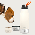 Load image into Gallery viewer, Alternate view of the Asobu Barky Bottle in white. The two detachable dog bowls are separated from the bottle; the stainless bowl and the white food bowl that nests within it. On the left is a cropped image of a beagle looking down toward the bowls.
