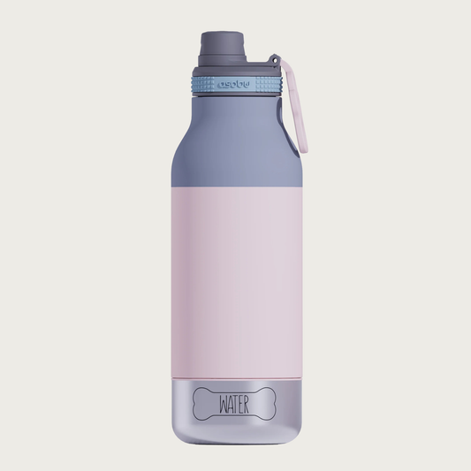 A pastel pink & gray insulated water bottle with a gray lid & drinking spout and a small, hollow, pastel pink, paw print shaped flip-up handle. The base is a small stainless steel bowl that screws into the bottle, with the outline of a dog bone with the word 'WATER' in its center. The steel bowl is flush with the sides of the water bottle - no part of it sticks out.
