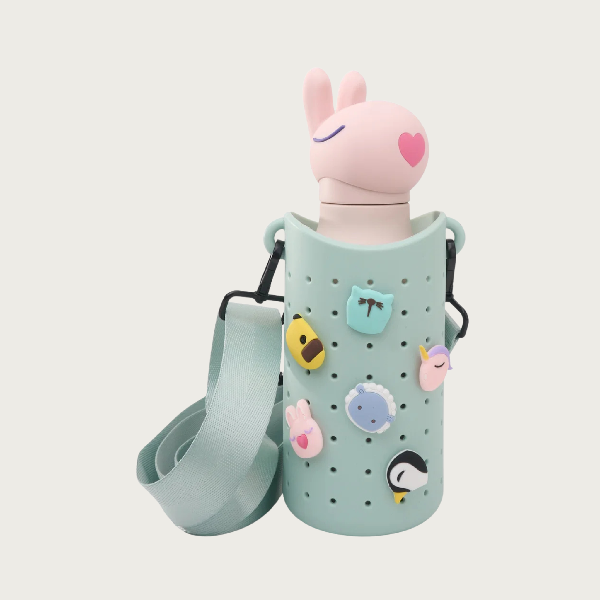 Alternate view of the Bestie Bottle Sling in Green, with a pink bunny Bestie Bottle inside.