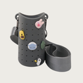 Load image into Gallery viewer, A dark gray silicone cup sleeve with a matching nylon shoulder strap, decorated with cute cartoon charms including a bunny, dog, sheep, frog, and penguin.
