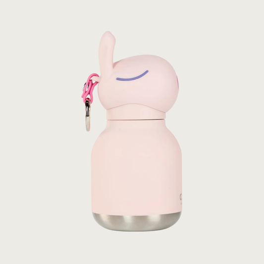 Side view of the Mini Bestie Bottle Bunny, showing it's closed eyes (curved purple line), dimensions of its ears, and bright pink loop on the back of the cap, where the keyring is attached.