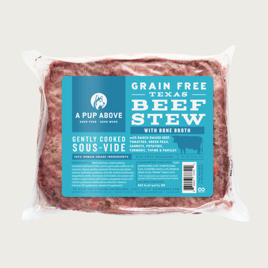 A shrink-wrapped, clear plastic pouch containing frozen, gently cooked Texas Beef Stew recipe dog food from A Pup Above. Blue label provides product details.