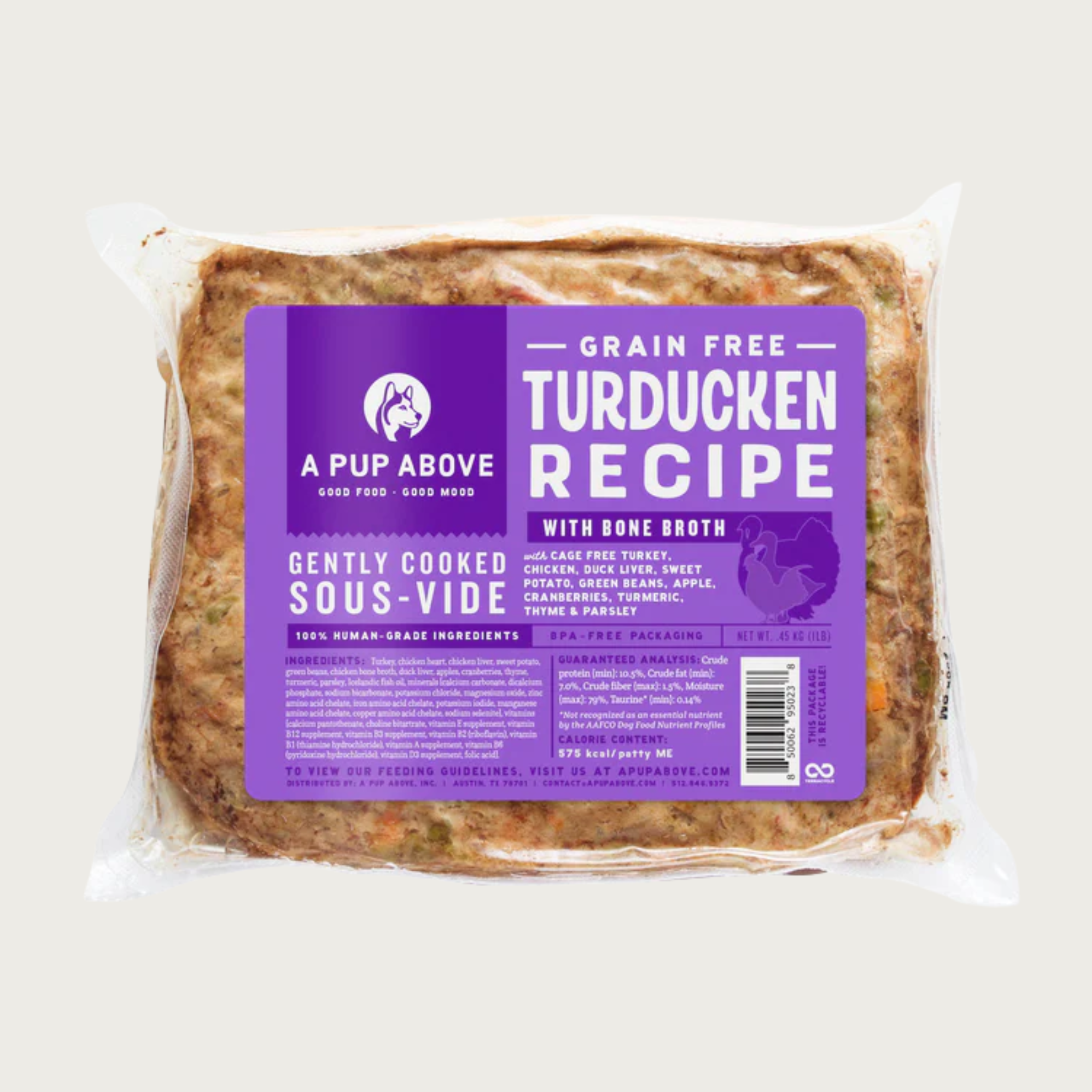 A shrink-wrapped, clear plastic pouch containing frozen, gently cooked turducken recipe dog food from A Pup Above. Purple label provides product details.