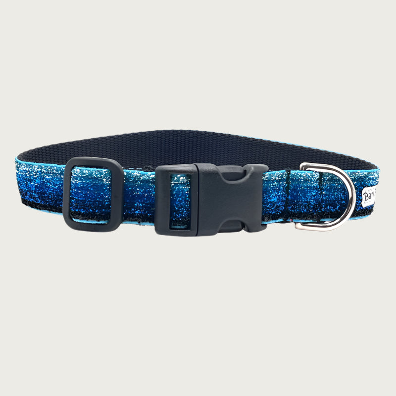 Blue gradient (light blue to deep blue) hued glitter 1" wide dog collar with a D-ring, black nylon inner webbing and black plastic buckle. The fabric itself is shimmery & glittery - it is not glued on.