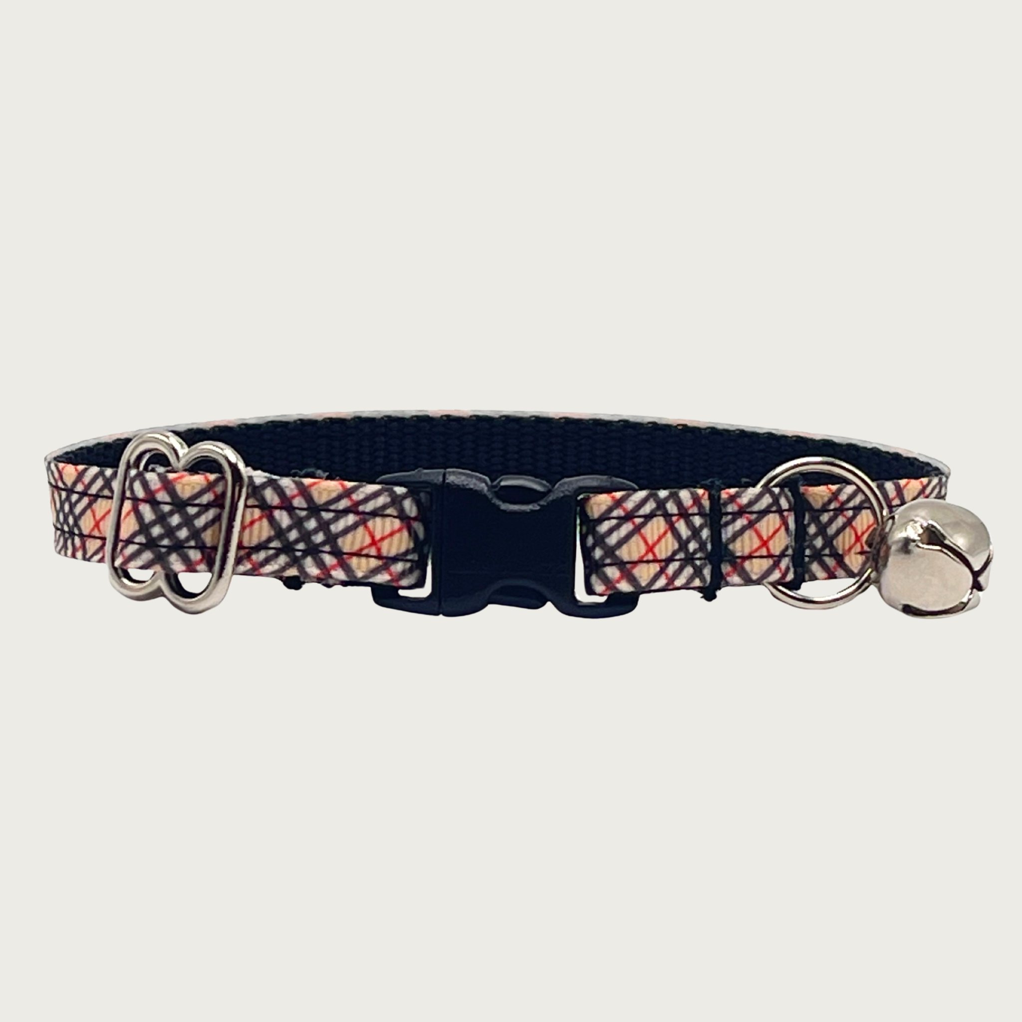 Cat collar with Burberry-style red, black, and tan plaid pattern with a small silver bell and black plastic buckle.
