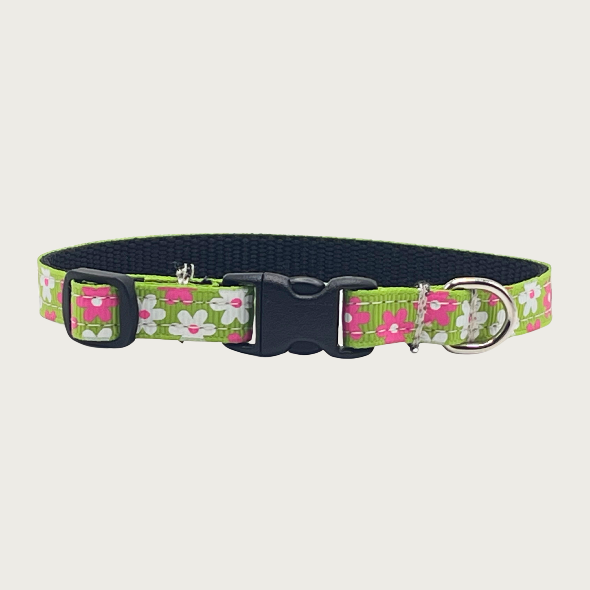 Skinny lime green dog collar with simple hot pink and white flowers. Has a small D-ring, black nylon inner webbing and black plastic buckle.
