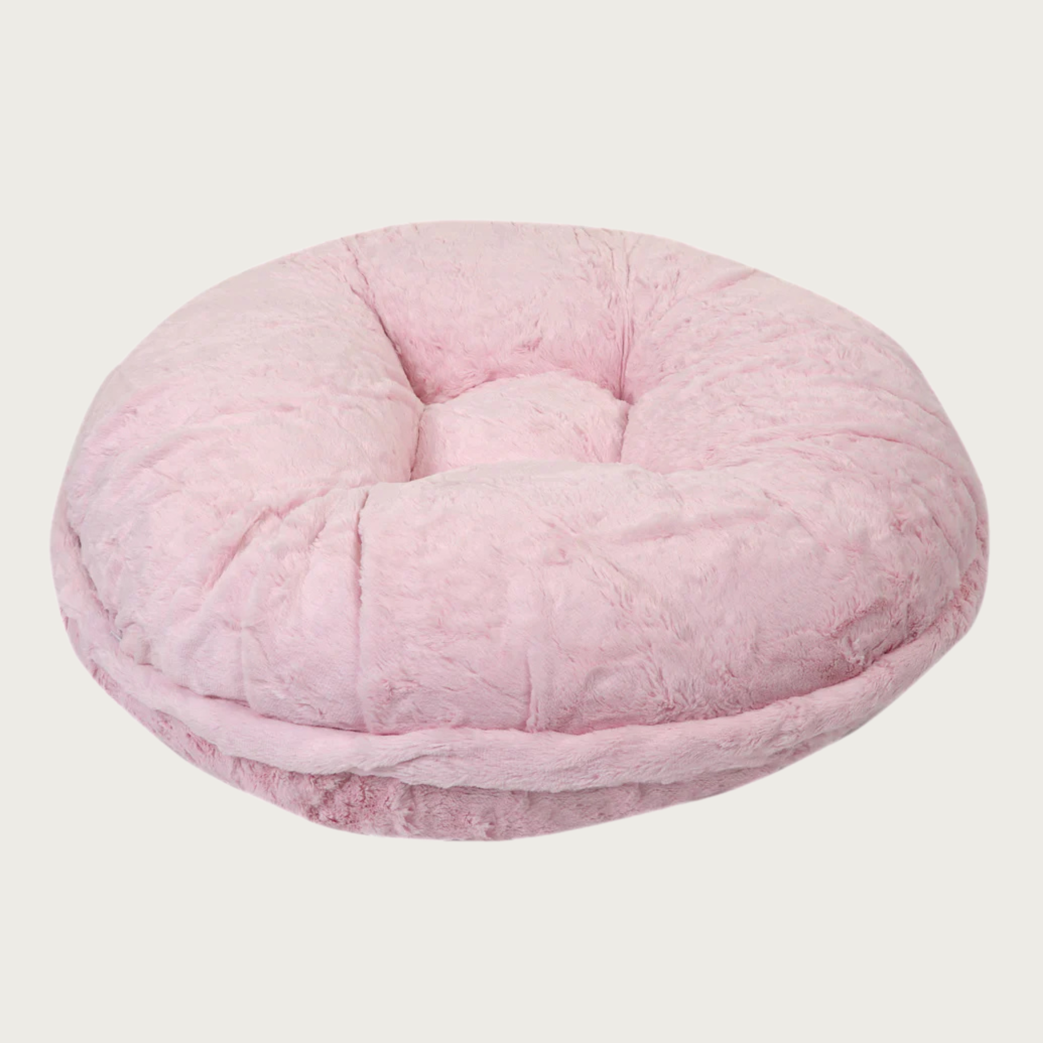 Side view of the Bagel Bed in Baby Pink Mink. A ring of fabric goes along the center edge of the bed, hiding the zipper.