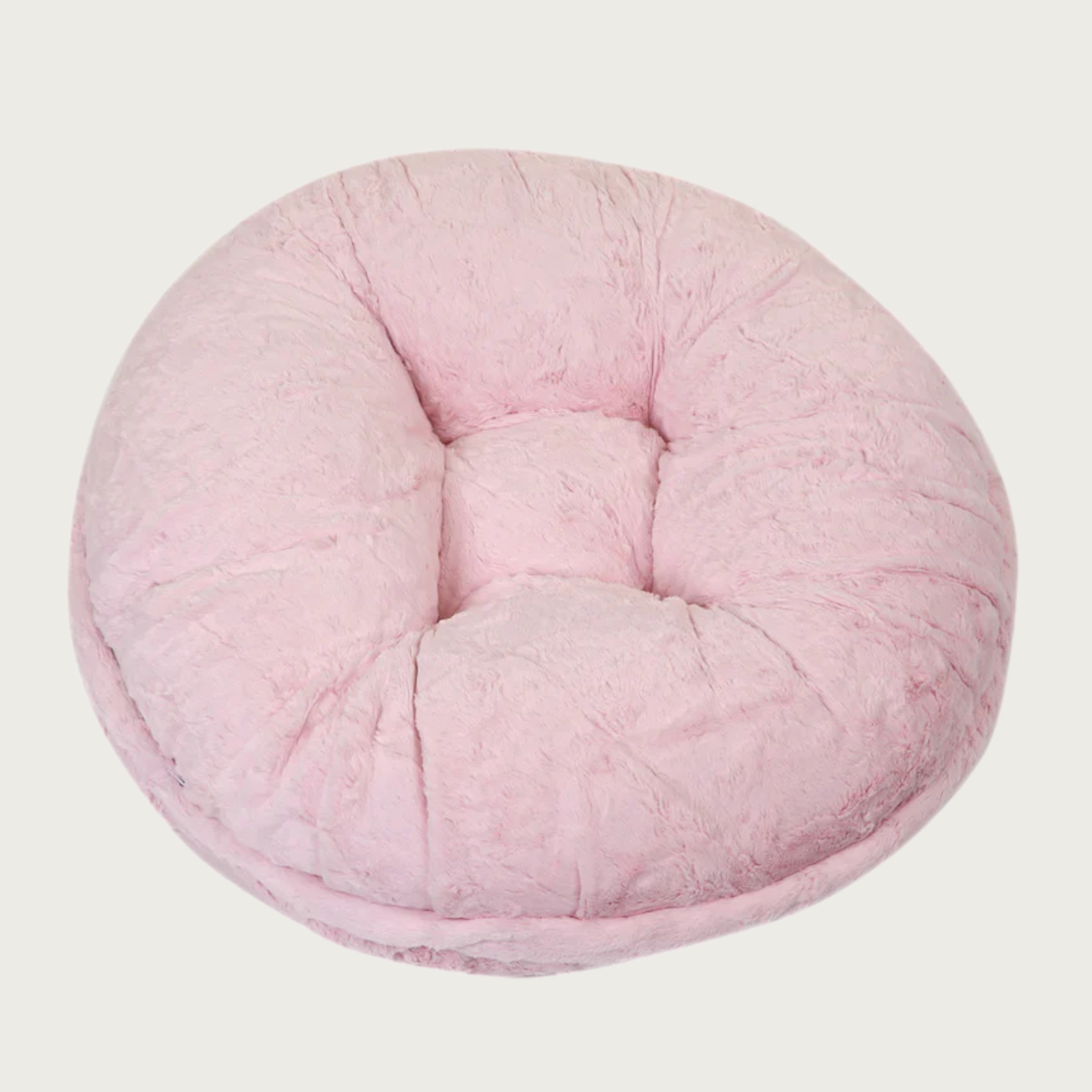 Round, pale pink colored plush pet bed with faux mink fur.