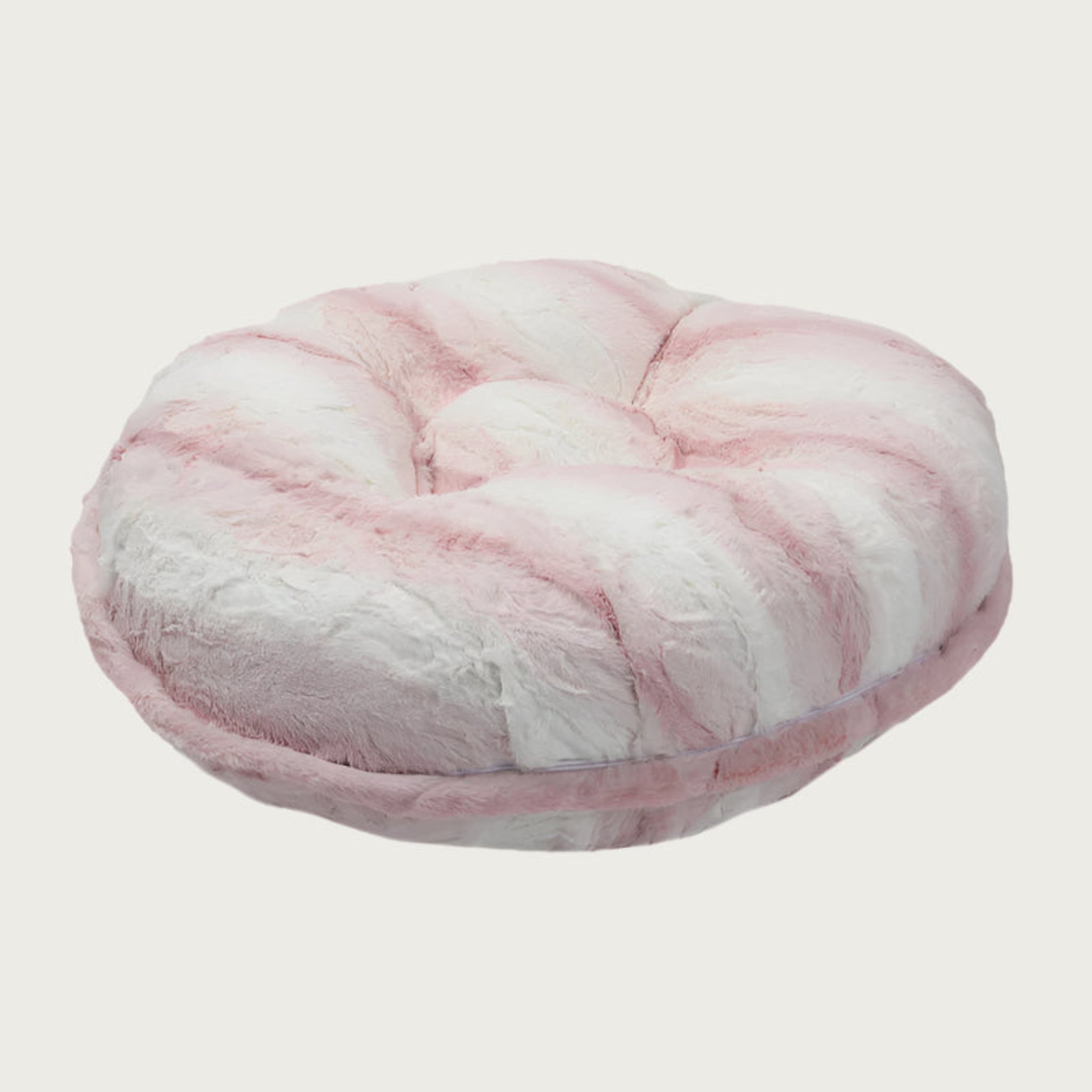 Side view of the Bagel Bed in Platinum Pink. A ring of fabric goes along the center edge of the bed, hiding the zipper.