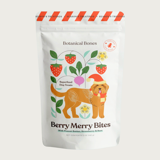 Bag of Botanical Bones Berry Merry Bites superfood dog treats with peanut butter, strawberry & beet. Packaging features an illustrated dog and botanical design.