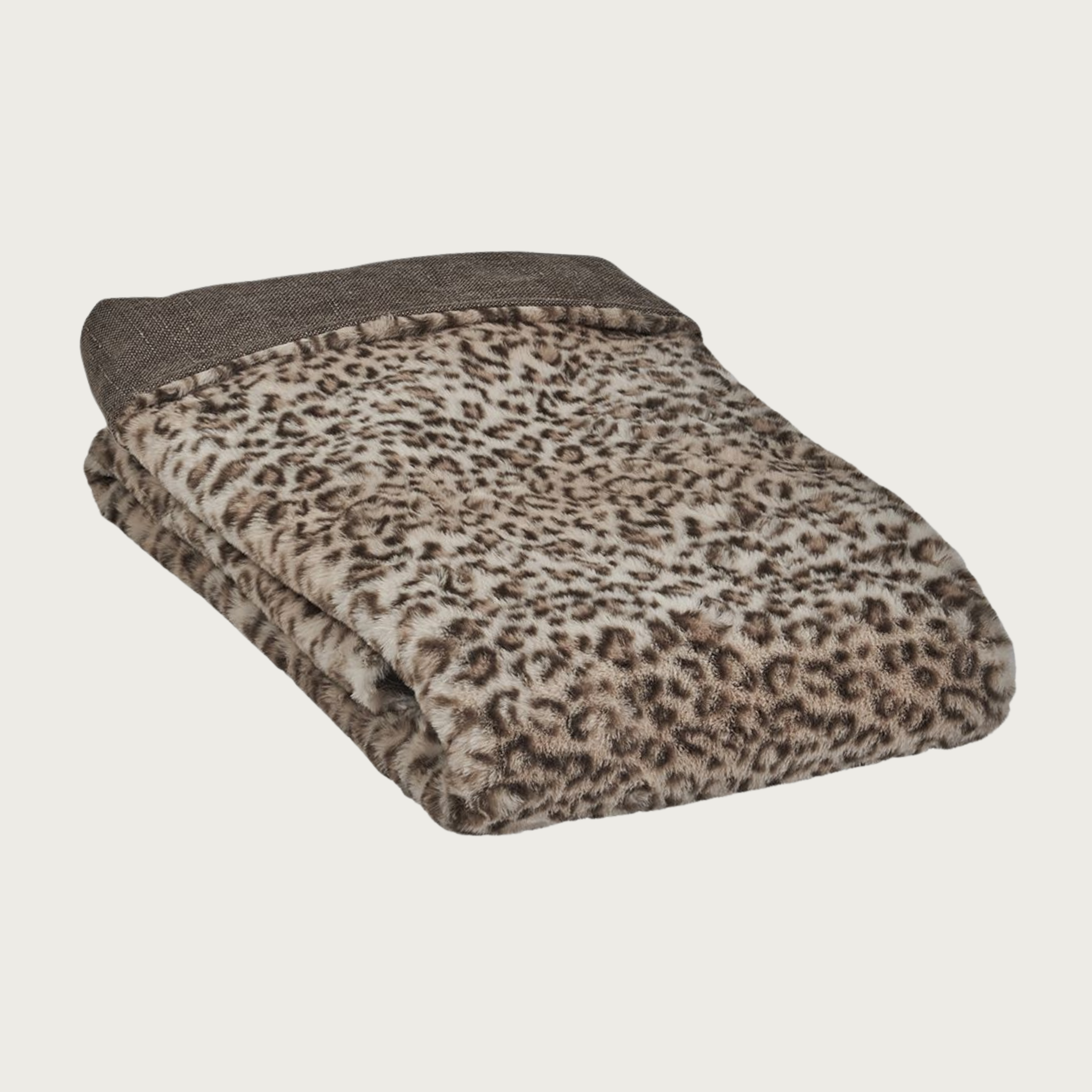Folded pet blanket in plush beige & dark brown leopard print, with solid brown/caramel cotton fabric on the reverse.