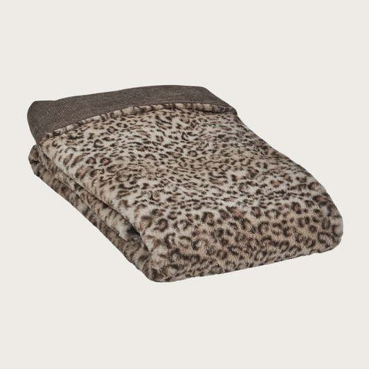 Folded pet blanket in plush beige & dark brown leopard print, with solid brown/caramel cotton fabric on the reverse.