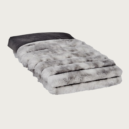 Folded pet blanket in plush faux fur with horizontal ridged texture, in muddled gray & white tones on the main side. Solid dark gray colored fabric on the reverse.