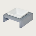 Load image into Gallery viewer, XS Single bowl, elevated dog feeder. Stand is a medium grey color, in a simple square design. Square white ceramic bowl in center.
