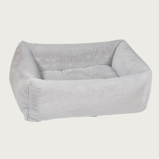 Light gray colored, faux fur plush rectangular pet bed with bolsters & tufted center cushion.