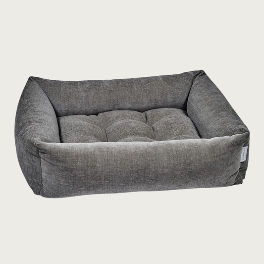 Mousse (medium grayish brown) colored, rectangular pet bed with bolsters & tufted center cushion. It has a slightly textured, stonewashed appearance.