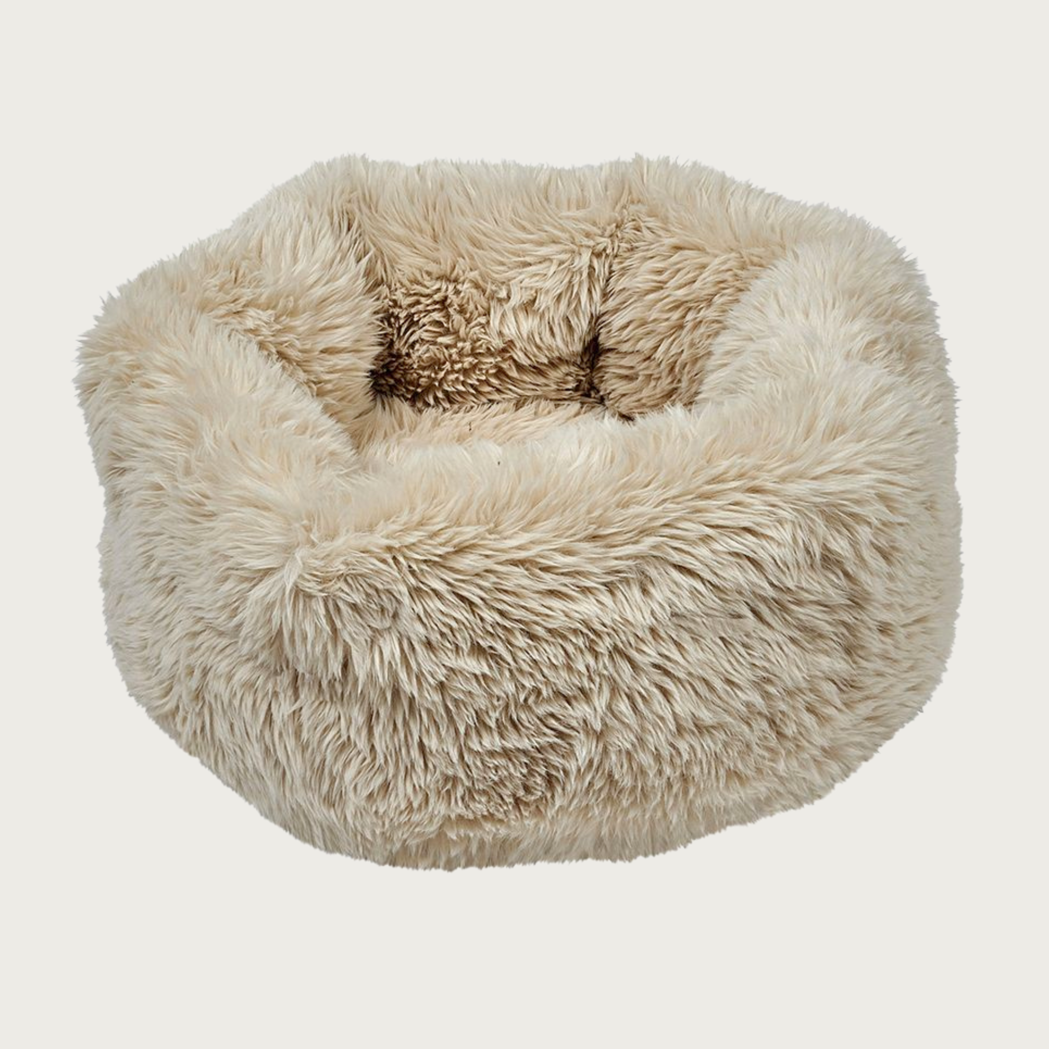 Plush, fluffy, nest-style pet bed with high sides, in light beige shaggy faux fur.