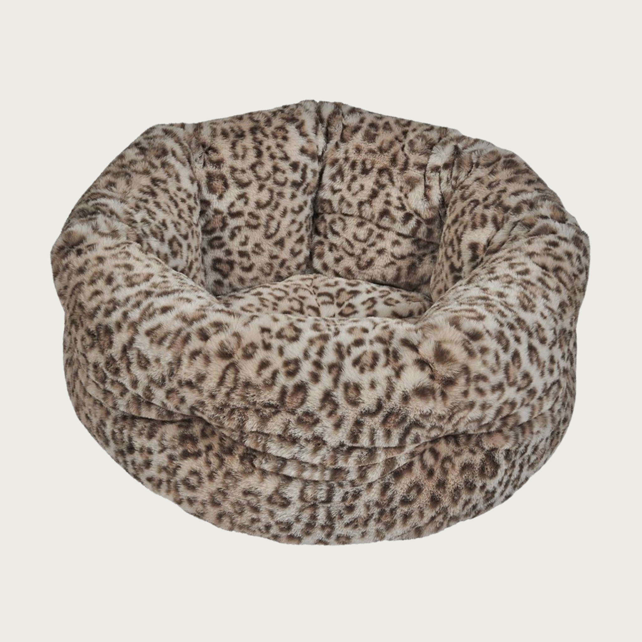Plush, nest-style pet bed with high sides, in a beige & dark brown leopard print.