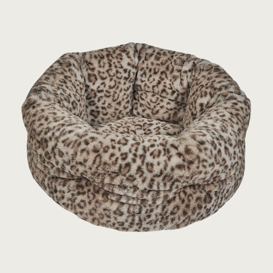 Plush, nest-style pet bed with high sides, in a beige & dark brown leopard print.