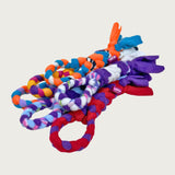 A stack of six Chelsy's Toys fleece tug toys for dogs, showing an example of some of the many possible color variations. Sample colors include: red, orange, white, purple, blue, pink and black.