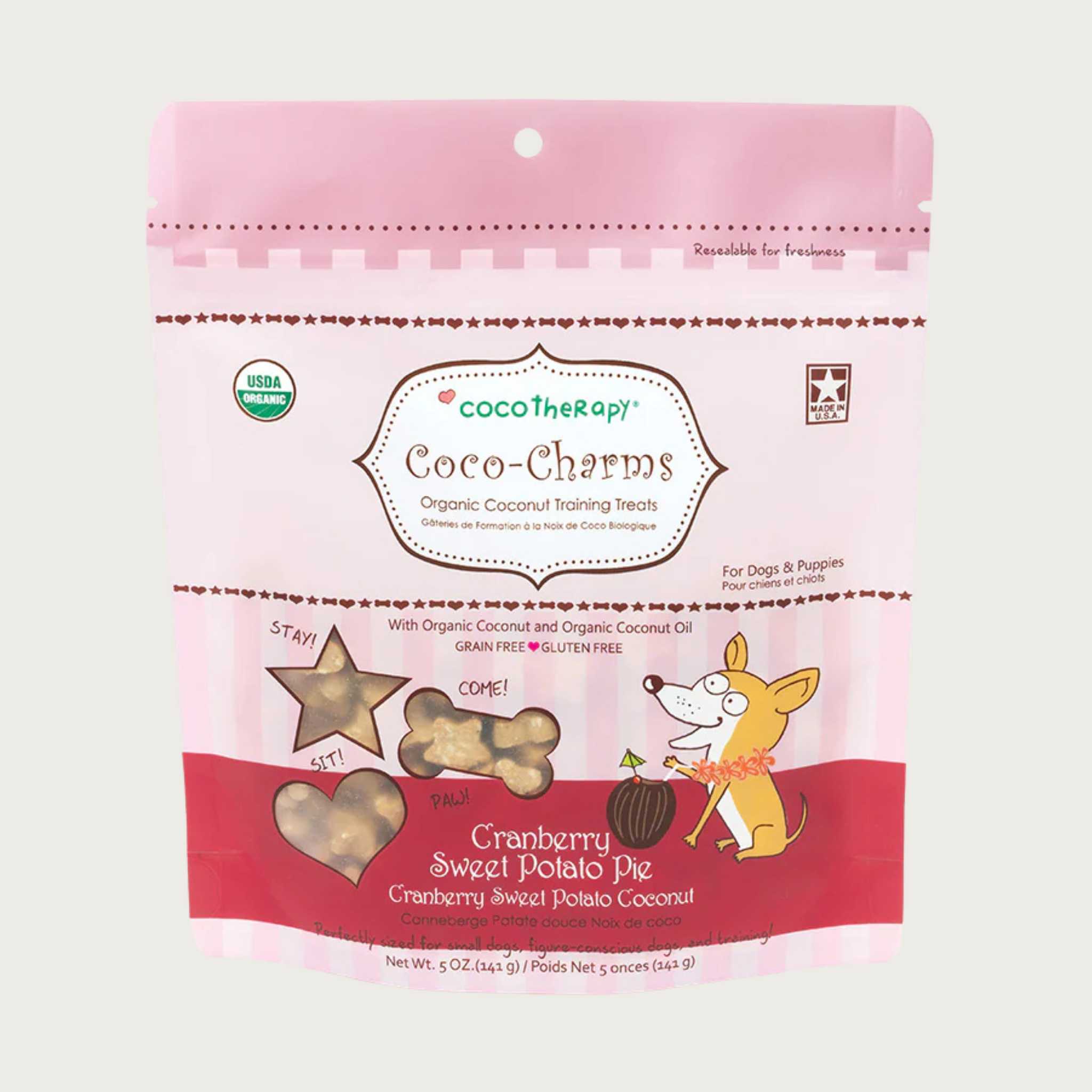5 oz pink bag of CocoTherapy Coco-Charms Cranberry Sweet Potato Pie organic coconut training treats for dogs. Made with coconut & coconut oil. Grain-free, gluten free. USDA organic, made in USA. Treats visible through 3 clear windows are tiny (smaller than a dime) and tan colored, and in three shapes: hearts, stars and bones.