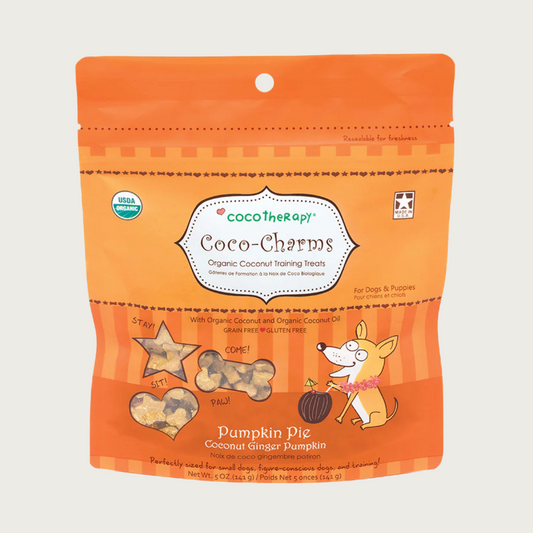 5 oz orange bag of CocoTherapy Coco-Charms Pumpkin Pie organic coconut training treats for dogs. Made with coconut & coconut oil. Grain-free, gluten free. USDA organic, made in USA. Treats visible through 3 clear windows are tiny (smaller than a dime) and tan colored, and in three shapes: hearts, stars and bones.