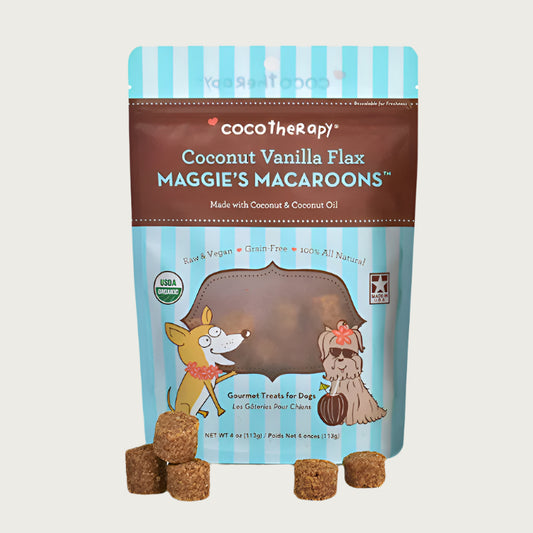 4 oz blue and brown bag of CocoTherapy Coconut Vanilla Flax Maggie's Macaroons gourmet treats for dogs. Made with coconut & coconut oil. Raw & vegan, grain-free, 100% all natural. USDA organic, made in USA. Sample treats in front of bag are brown, and look like tater tots.