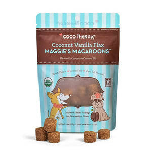 4 oz blue and brown bag of CocoTherapy Coconut Vanilla Flax Maggie's Macaroons gourmet treats for dogs. Made with coconut & coconut oil. Raw & vegan, grain-free, 100% all natural. USDA organic, made in USA. Sample treats in front of bag are brown, and look like tater tots.