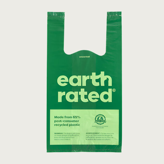 Single green plastic bag with two handles and 'Earth Rated' branding. Made from 65% post-consumer recycled plastic.