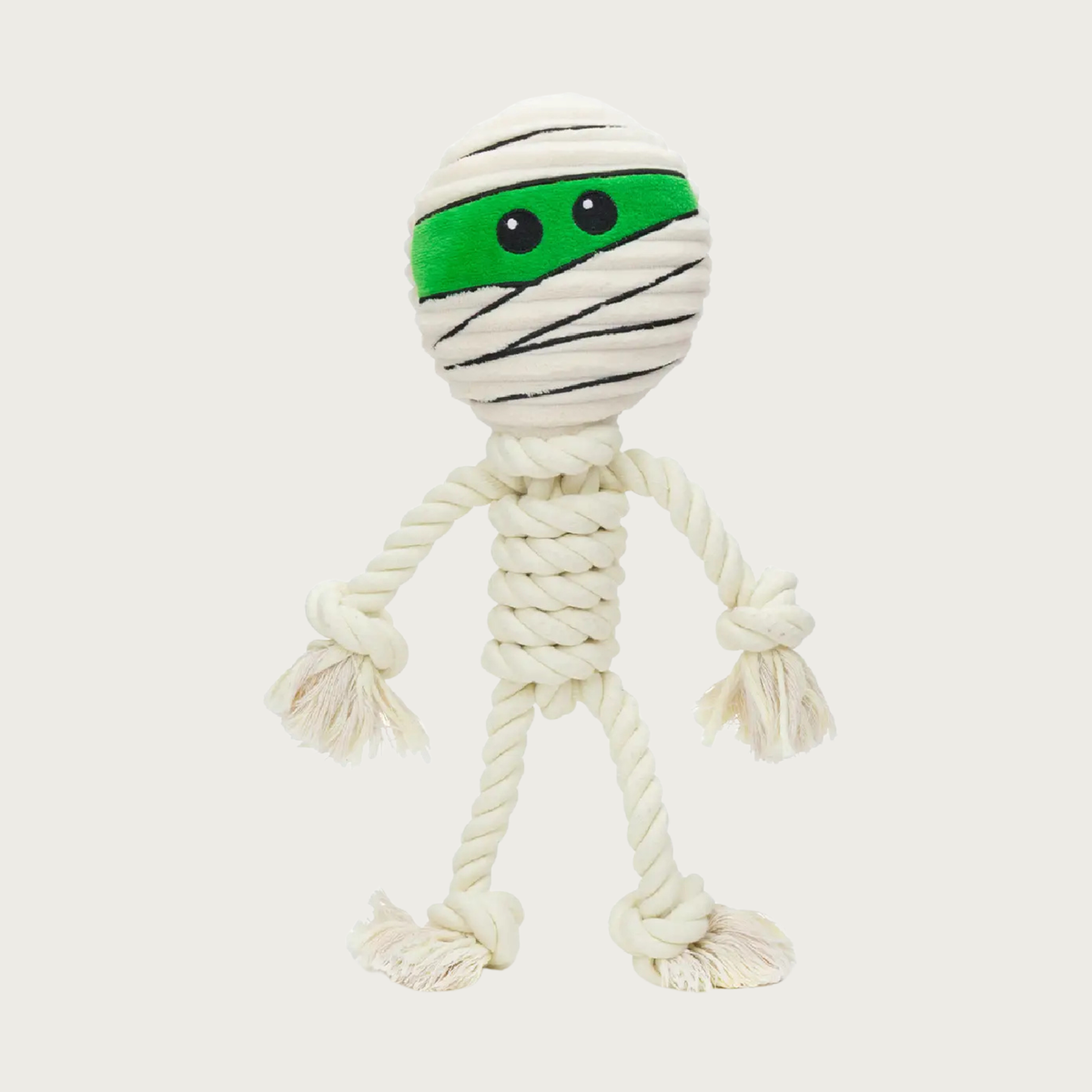Halloween themed dog toy shaped like a mummy. It has a white rope body with dangling white arms & legs. Its plush head is wrapped in white bandage details, with a strip of its bright green face & black eyes peeking out.