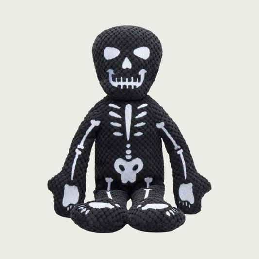 Halloween-themed plush skeleton dog toy. It has a black textured plush body with embroidered white skeleton bone details.